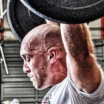 Nathan Cowles training with a barbell overhead